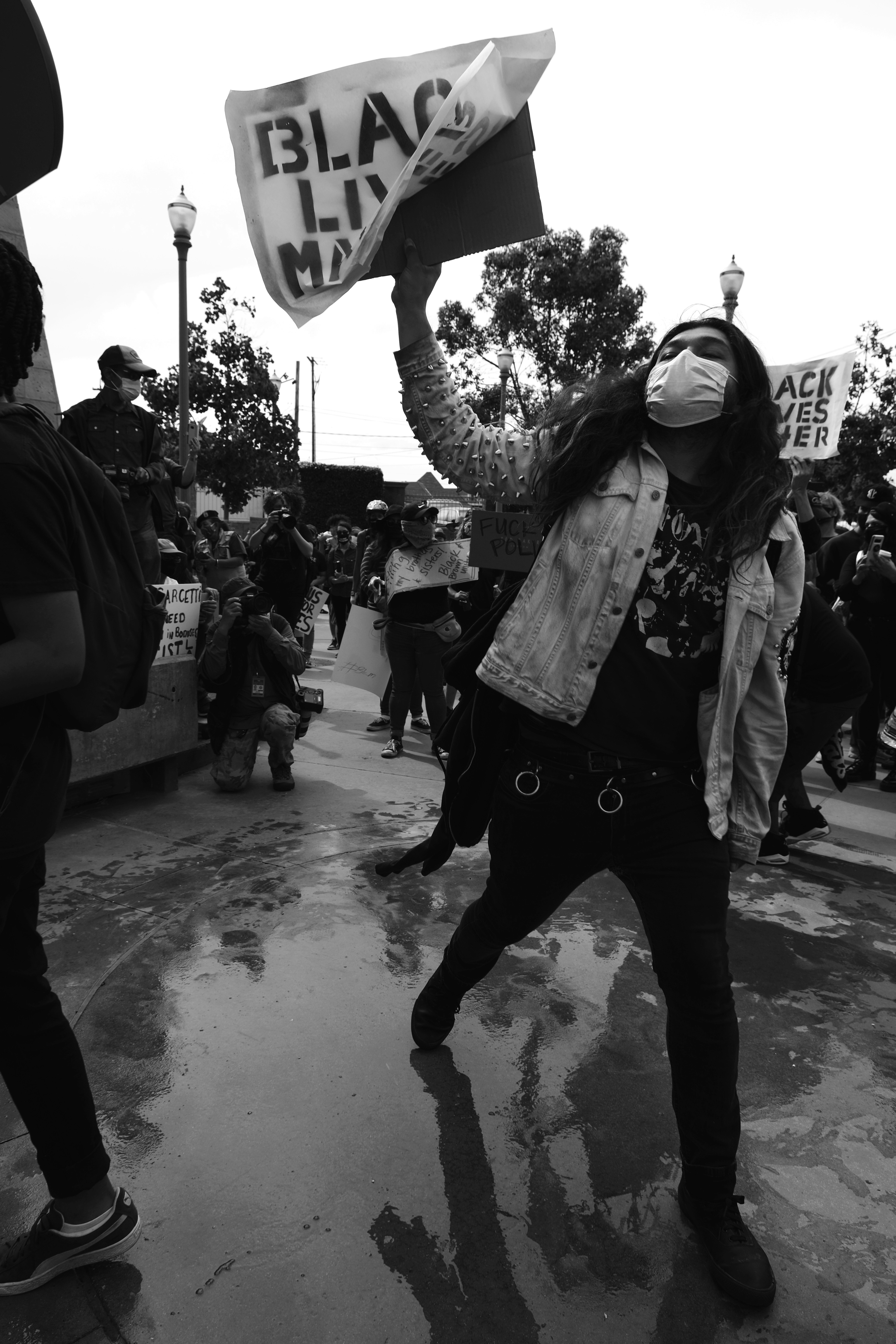 grayscale photo of man in jacket and pants holding a girl in jacket